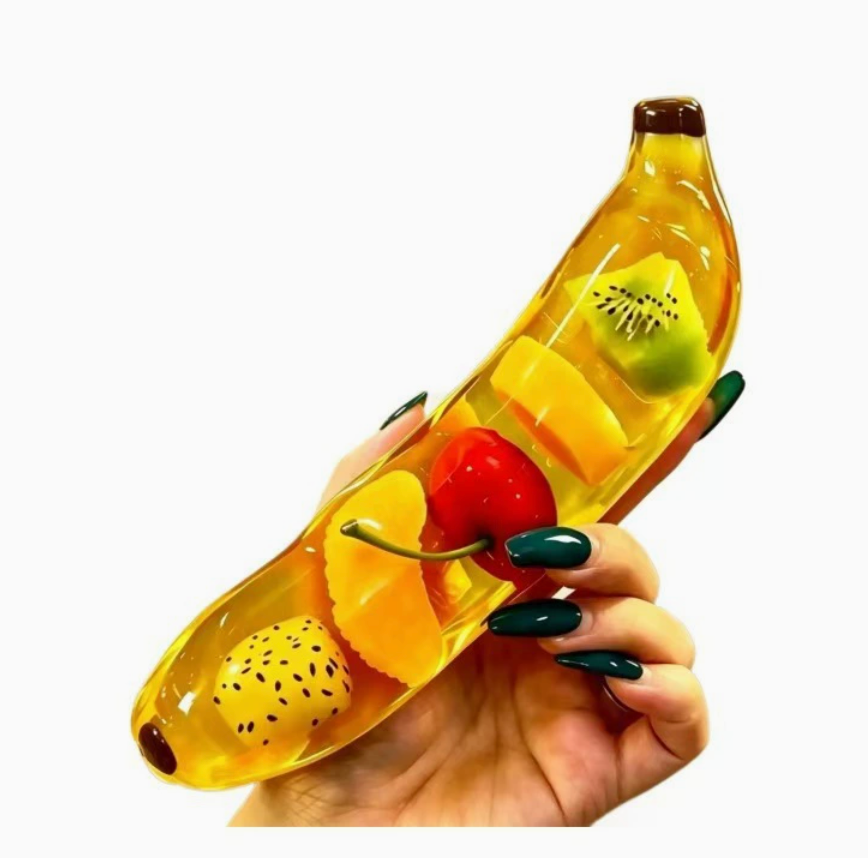 Transparent banana fruit gel squishy held in one hand