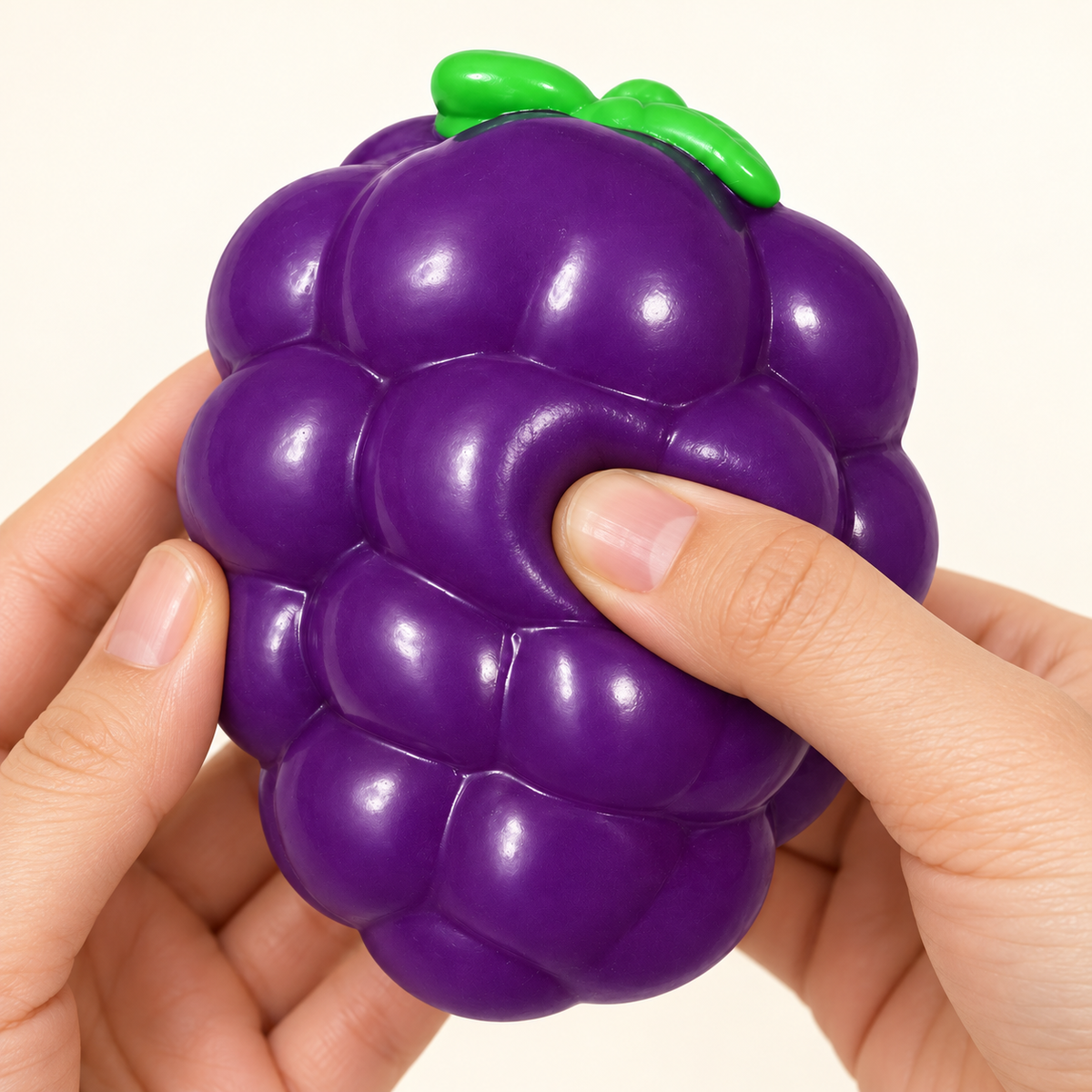 Illustration of gentle squeezing of the purple grape toy