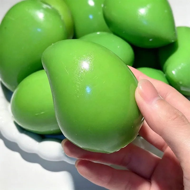 Green mango squishy shown in hand